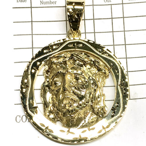 This bold and beautifully detailed 14K solid gold Jesus face medallion is a powerful expression of faith and style. Handcrafted and polished to a high shine, this religious pendant features a textured, three-dimensional image of Christ crowned with thorns, framed in a decorative border. Available exclusively at Ayala’s Jewelry in Huntington Park, it’s ideal for anyone seeking meaningful, statement-making gold jewelry rooted in culture and devotion.